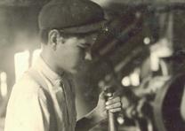 A fifteen-year-old boy operates a boring machine at the Pittman Handle Factory in Texas, photographed by Lewis Hine, 1913. (Library of Congress Prints and Photographs Division) Teenager operating machinery, 1913, by Lewis Hine. (LC-DIG-nclc-04898)