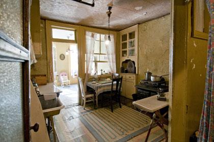 The kitchen and parlor of the restored Baldizzi apartment at 97 Orchard Street. Note the bare light bulb and the cast iron stove. (Photography by Keiko Niwa, courtesy LESTM) The kitchen and parlor of the restored Baldizzi apartment at 97 Orchard Street.
