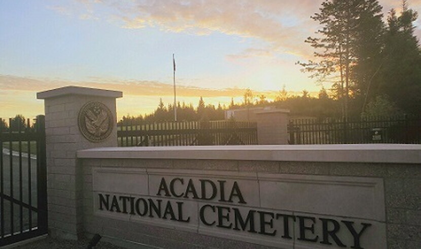 View of sunrise over entrance to Acadia National Cemetery