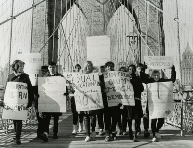 Black and white photograph of students protesting on Brooklyn Bridge