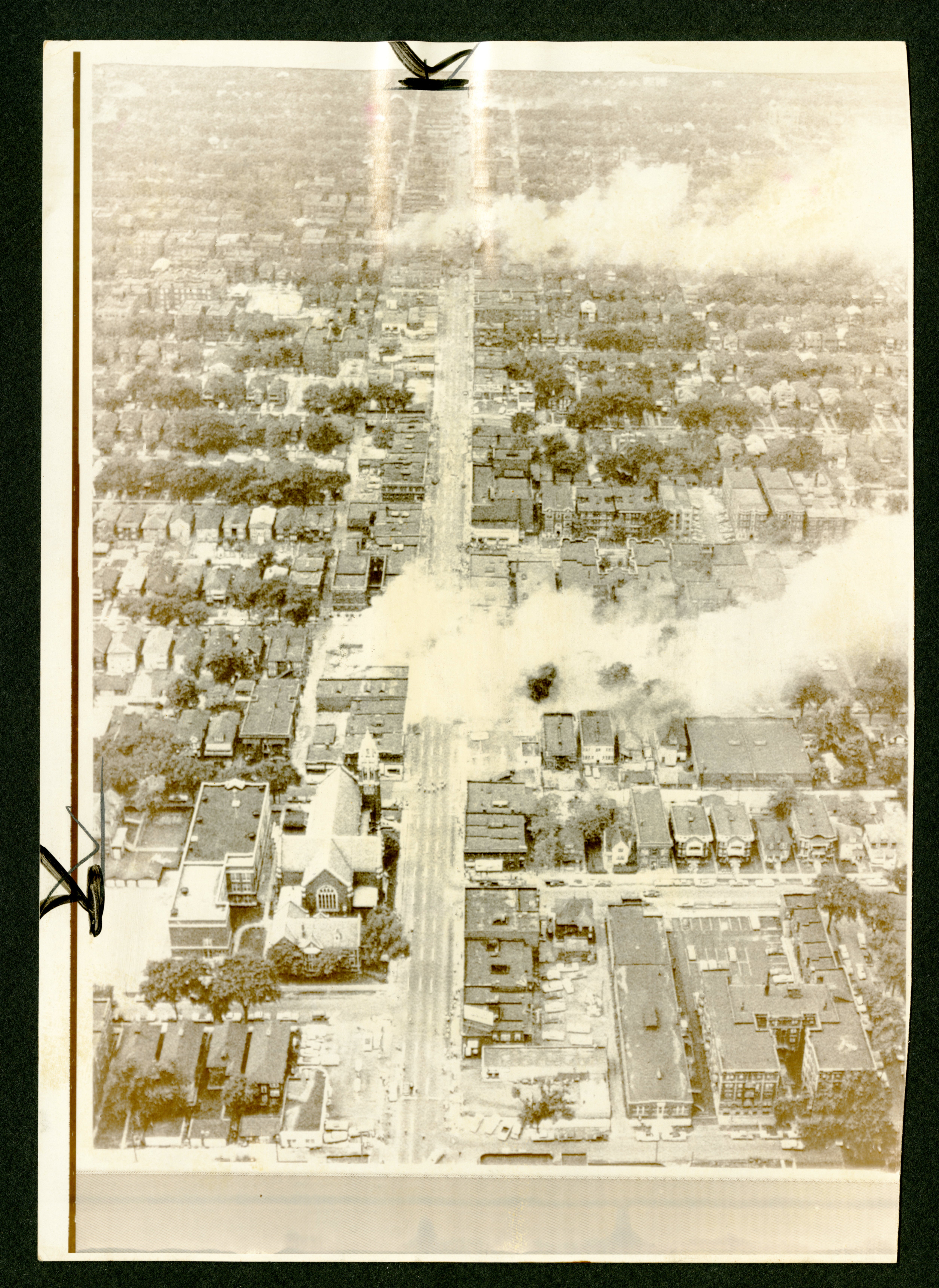 "Smoke erupts from two widely separated areas in slum area" (The Gilder Lehrman Collection, GLC09735.07)