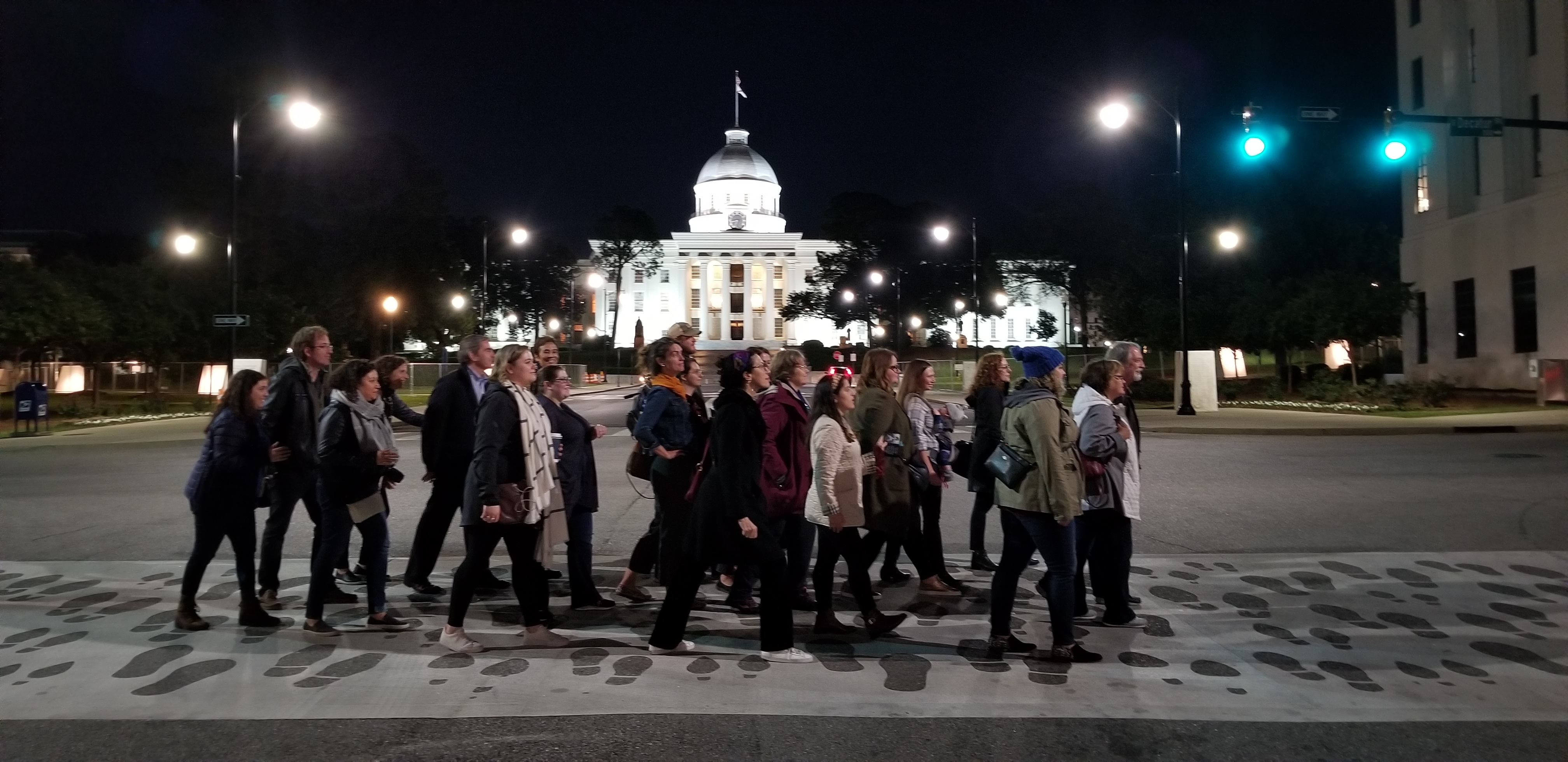 Gilder Lehrman Institute staff in front of the Montgomery capitol building, stepping on footprints marking the 50th Anniversary of the Selma to Montgomery March