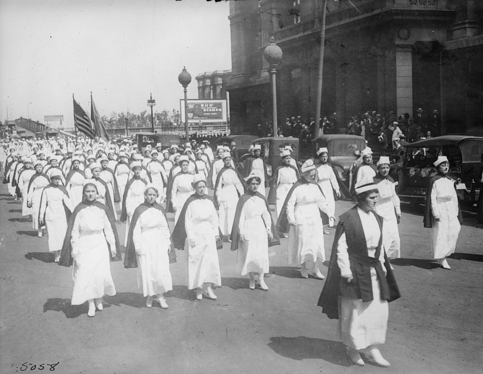 Black and white photo of nurses marching in Chicago to encourage volunteers during the 1918 Spanish flu. (Library of Congress)