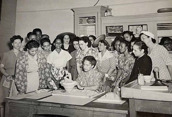 Meta Vaux Warrick Fuller, seated, teaching a women's sculpture course, ca. mid-1900s. (Photographs and Prints Division, Schomburg Center for Research in Black Culture, NYPL)