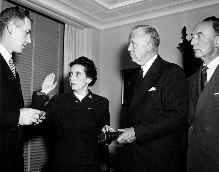 Anna M. Rosenberg is pictured being sworn in as Assistant Secretary of Defense in this photo. Doing the honors is Felix Larkin (left) General Counsel of the Department of Defense. Also participating in the ceremony are General George C. Marshall (second from right), and Robert A. Lovett, (right), Deputy Secretary of Defense,  November 15, 1950 (Harry S. Truman Library & Museum, National Archives)