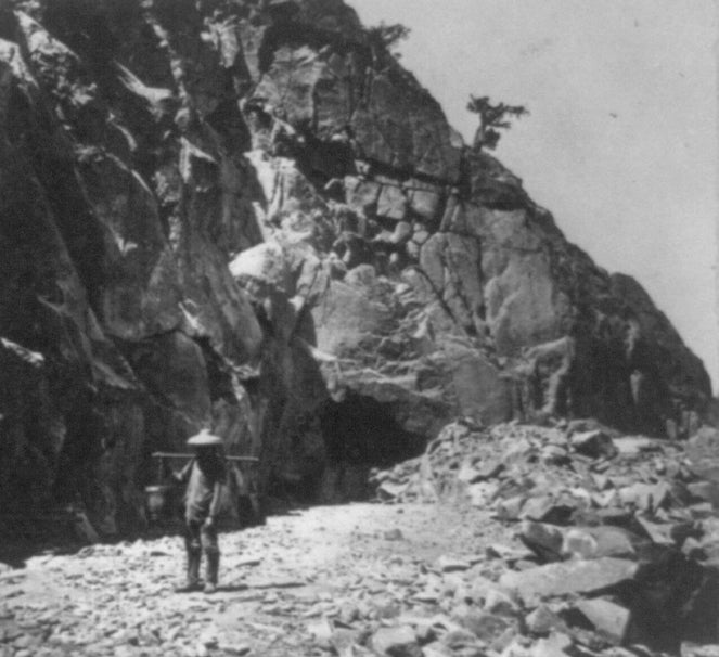 “Heading of East Portal Tunnel No. 8,” photograph by Alfred A. Hart depicting a Chinese worker for the Central Pacific Railroad in California, ca. 1865–1869 (Library of Congress)