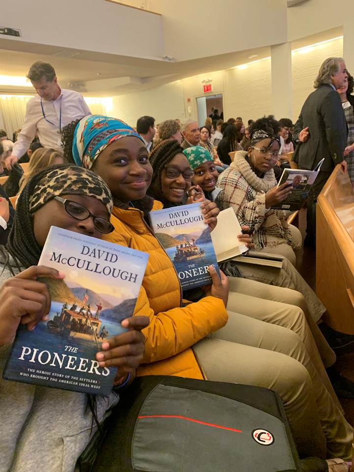 Students from Brooklyn East Collegiate display their copies of David McCullough's latest book at the Trinity School.