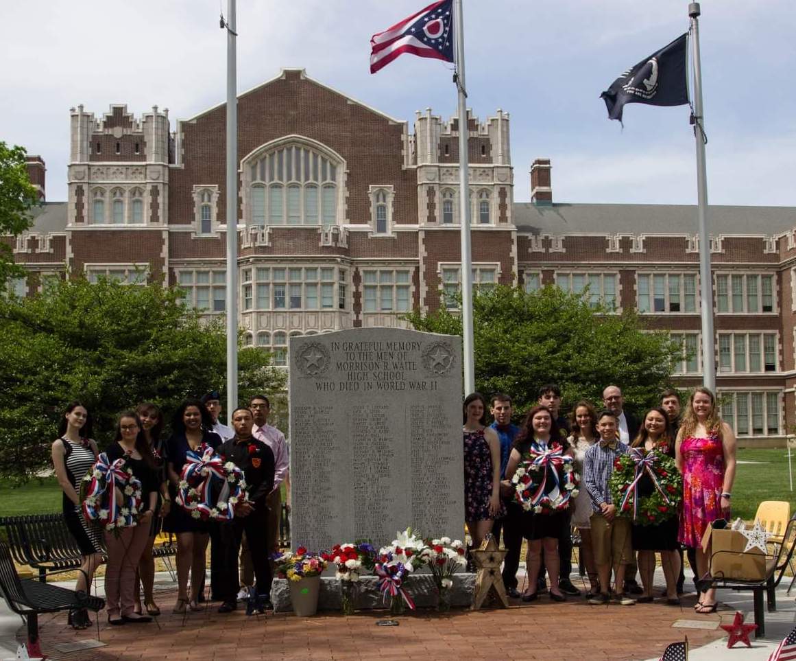 Ohio History Teacher of the Year Joseph Boyle with his students at the memorial for fallen World War II soldiers at Waite High School