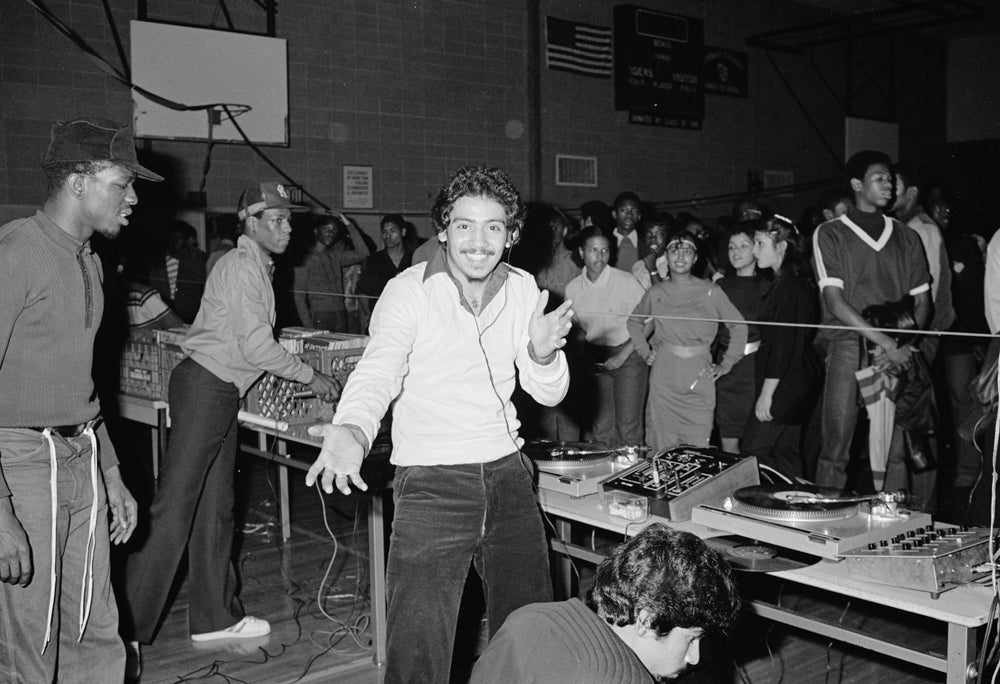 DJ Charlie Chase (Carlos Mandes) of the Cold Crush Brothers getting ready for a hip hop performance at Taft High School in the South Bronx in 1981. (Joe Conzo Archives)