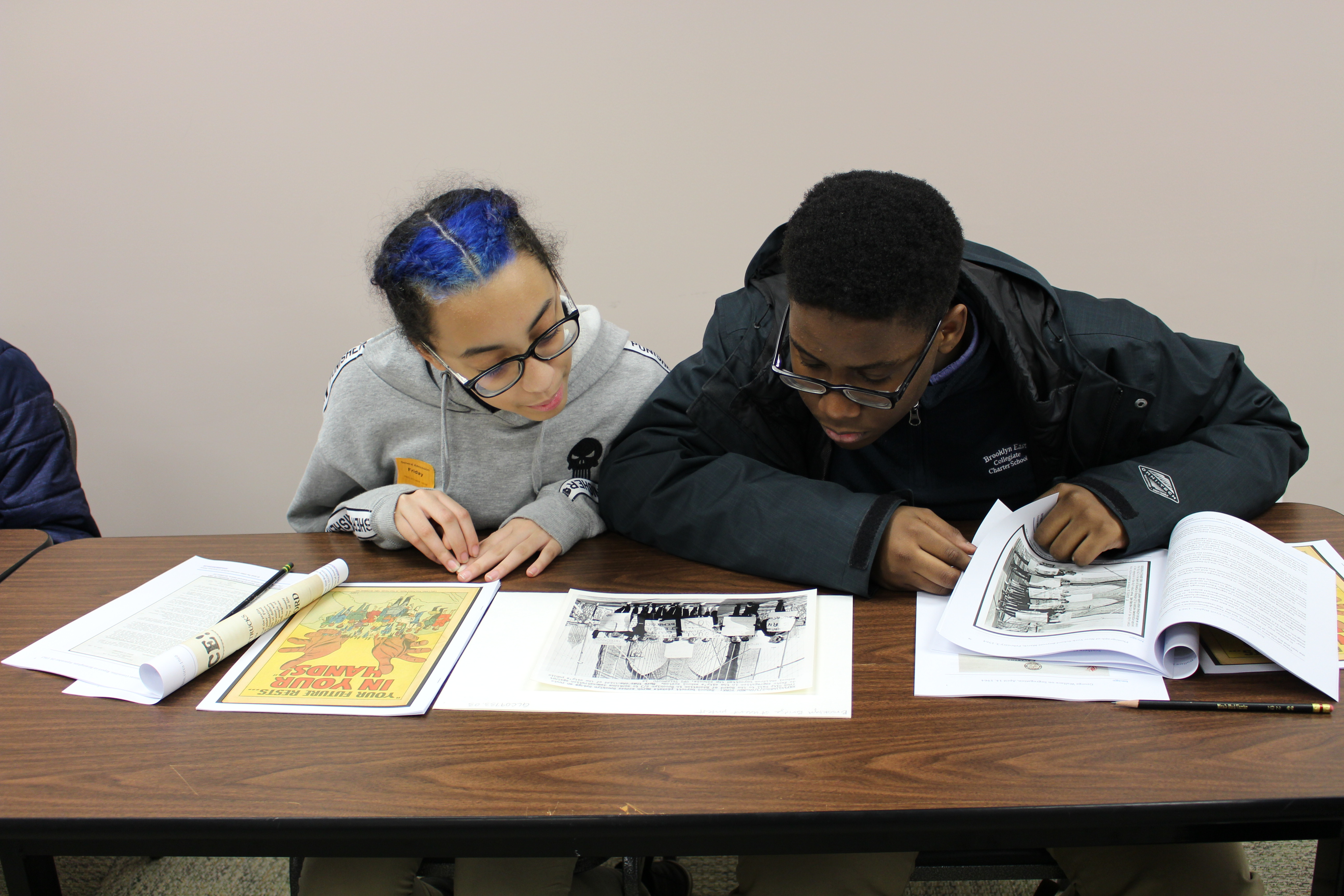 Students examine a UPI photograph of the New York School Boycott March, February 3, 1964. (The Gilder Lehrman Institute of American History, GLC09733.03)