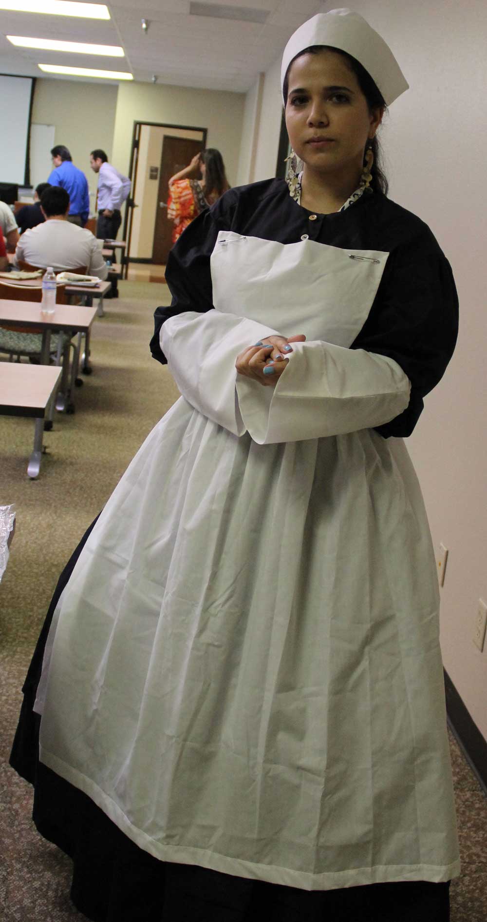 CHAPS graduate assistant Miriam Cepeda wearing a Civil War style nurse’s outfit at a workshop for teachers to explore the contents of the traveling trunk exhibits. Copies of this outfit are included in the twenty-two traveling trunks that have been assembled for use by teachers. (Courtesy of the Community Historical Archaeology Project with Schools, University of Texas Rio Grande Valley)