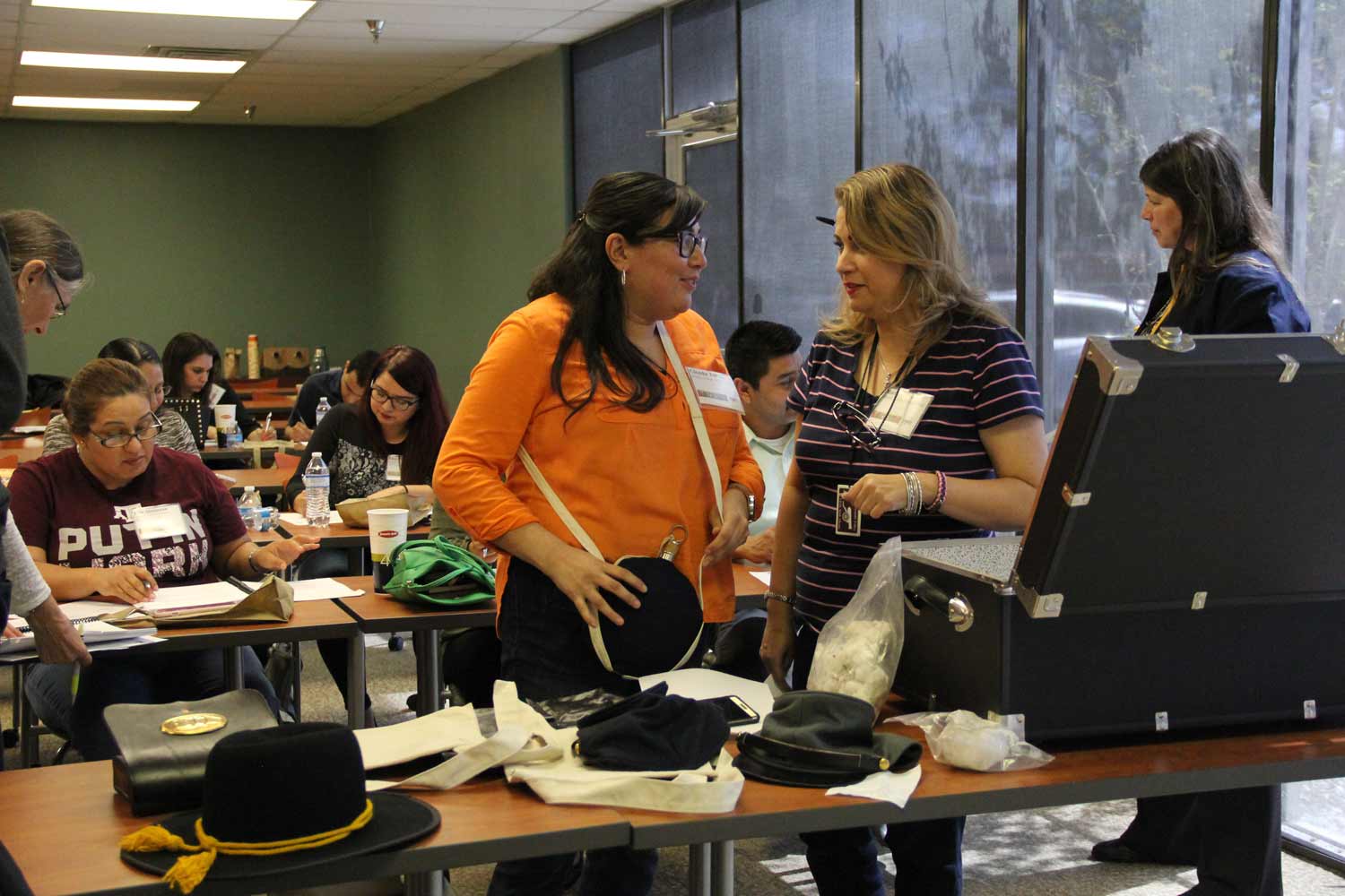 Teachers from fourth, seventh, and eighth grade and high school AP classes examining and providing feedback about contents for traveling trunk exhibits for use in their classrooms. Twenty-two trunks will be distributed to schools that have registered an interest in having them. (Courtesy of the Community Historical Archaeology Project with Schools, University of Texas Rio Grande Valley)