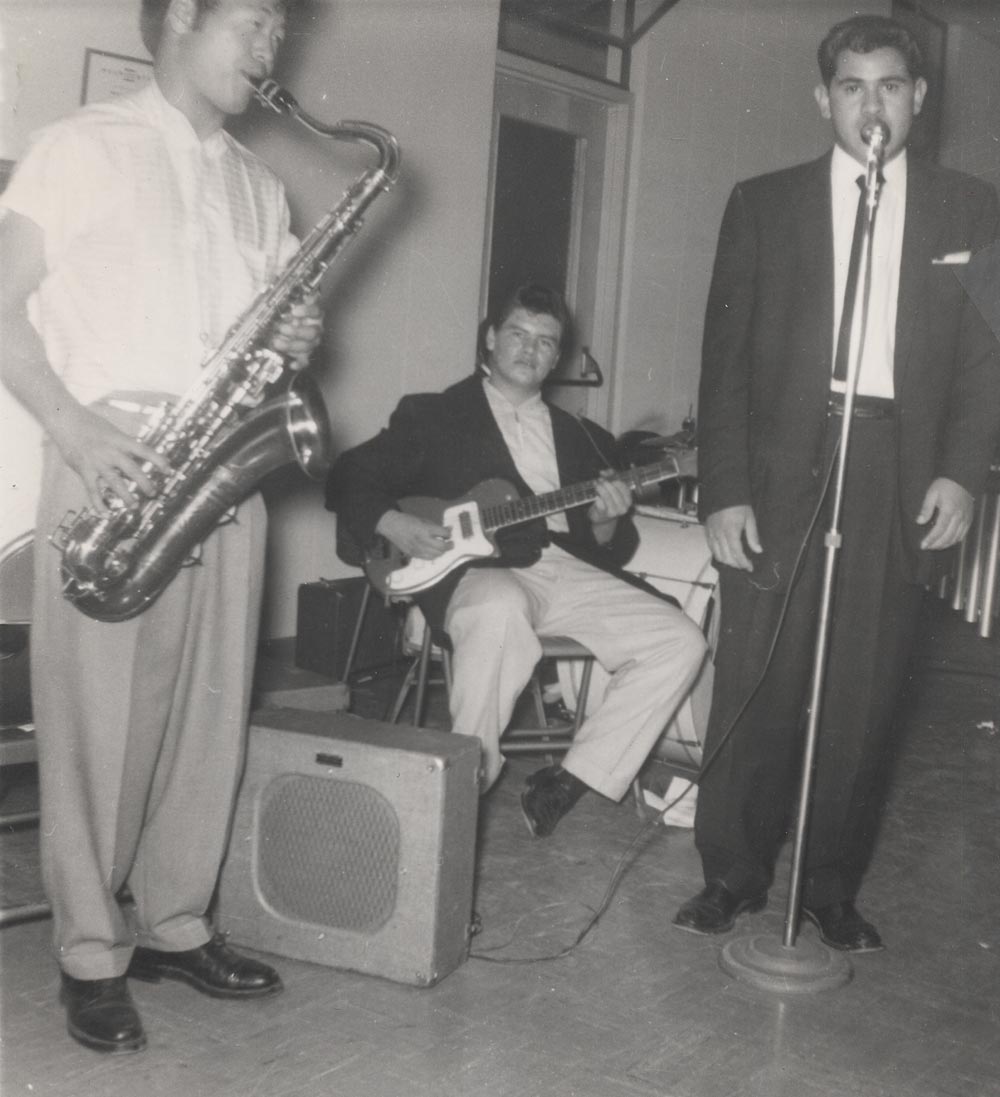 Ritchie Valens playing guitar with high school classmates in the Silhouettes, a band led by vibraphonist Gil Rocha. Walter Takaki plays saxophone, Walter Prendez is at the mic, and African American drummer Conrad Jones is hidden behind Valens. (Courtesy of Gil Rocha)