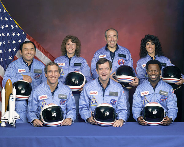 The STS-51-L crew: (back row from left) Mission Specialist Ellison S. Onizuka, Teacher in Space Participant Christa McAuliffe, Payload Specialist Greg Jarvis, and Mission Specialist Judy Resnik; (front row from left) Pilot Mike Smith, Commander Dick Scobee, and Mission Specialist Ron McNair. (NASA photo)