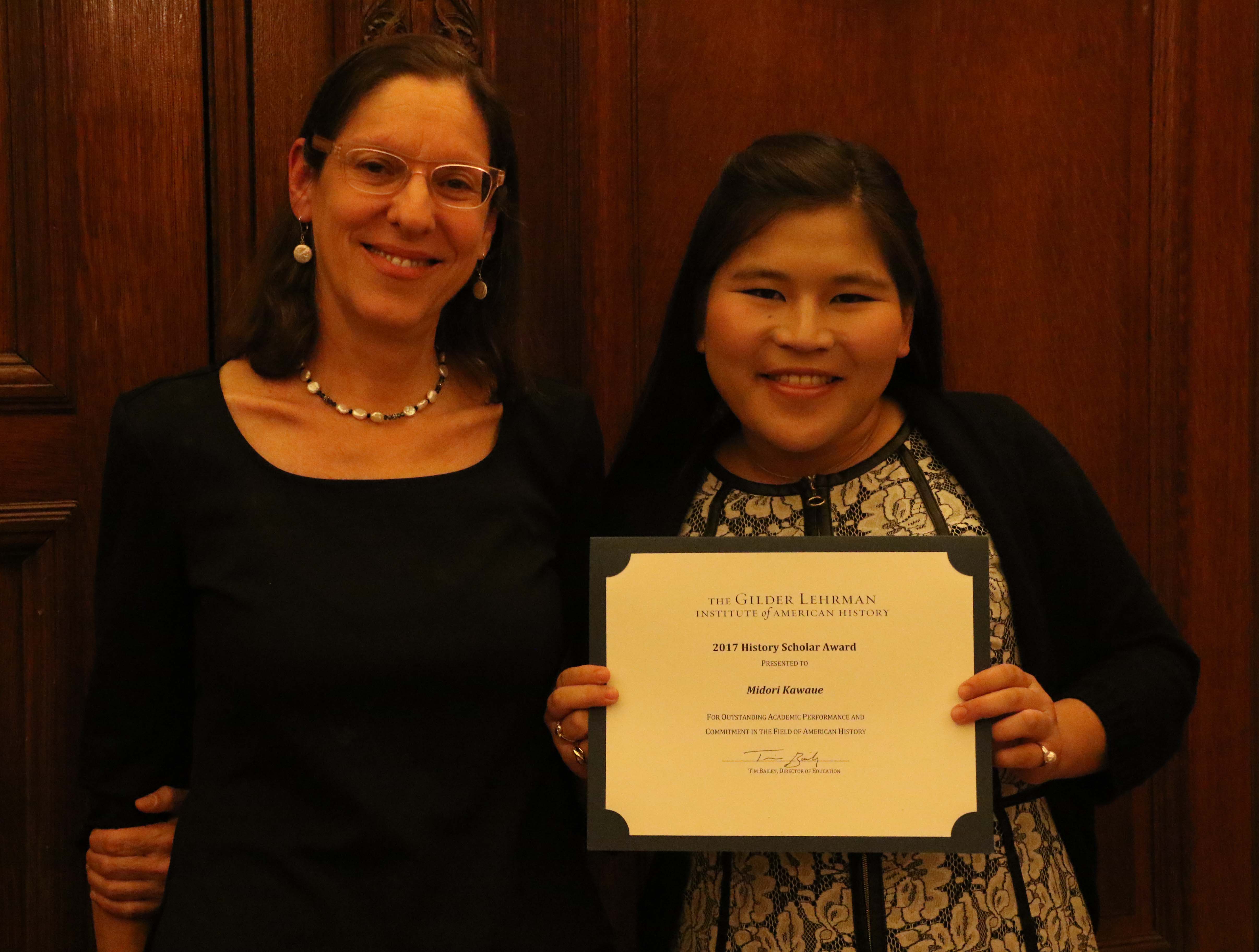 Midori receives her History Scholar Award from historian Martha Hodes