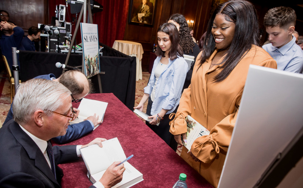 Jonathan W. White and Jon Meacham sign their Lincoln Prize-winning books for Affiliate School students attending the prize ceremony at the Harvard Club in New York City.
