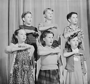 Fifth graders pledge allegiance at a War Production Board presentation, 1942 (Library of Congress)