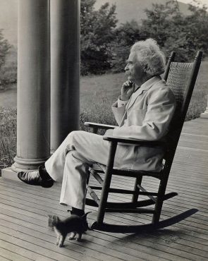 Samuel L. Clemens in rocking chair, 1906.