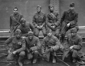 Soldiers of the 369th who won the Croix de Guerre, 1919. Front row: Pvt. Ed Williams, Herbert Taylor, Pvt. Leon Fraitor, Pvt. Ralph Hawkins. Back Row: Sgt. H. D. Prinas, Sgt. Dan Storms, Pvt. Joe Williams, Pvt. Alfred Hanley, and Cpl. T. W. Taylor. (National Archives)