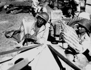 An American and a Chinese soldier plant flags upon completion of the Ledo Road, 