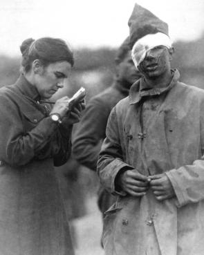Salvation Army worker writing a letter for a wounded soldier during World War I,