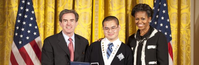 James G. Basker, president of the Gilder Lehrman Institute, and Robert Sandoval, participant in the Gilder Lehrman Saturday Academy at All Hallows in the Bronx, receive award from First Lady Michelle Obama.