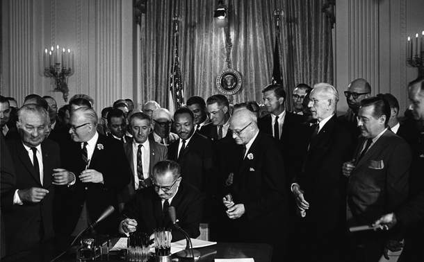 Lyndon B. Johnson signing a bill into law