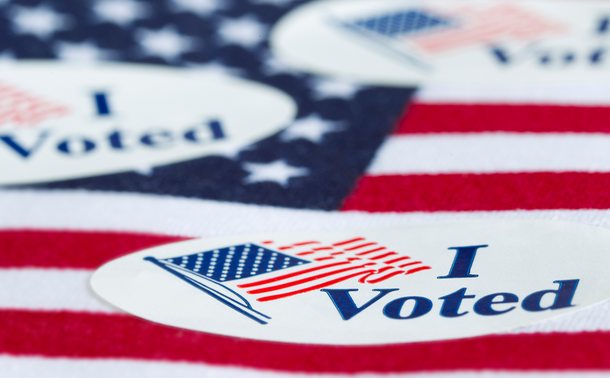 "I Voted" sticker resting on an American flag