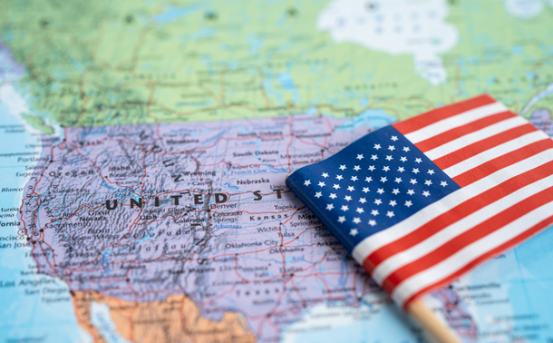 American flag resting atop a map of the United States