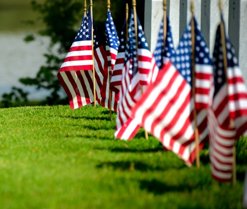 Cemetery with row of veteran graves with US flags