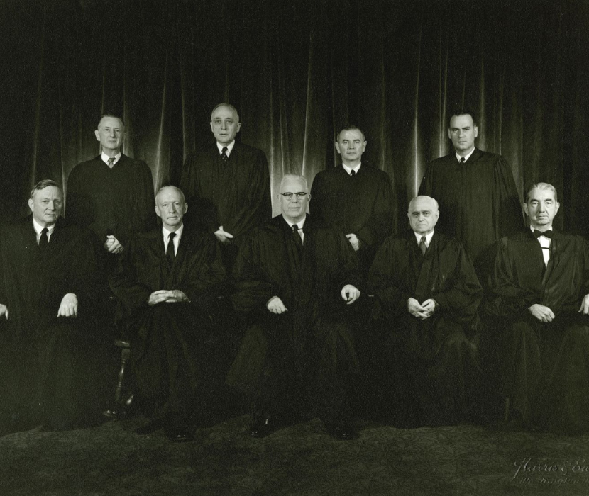Black and white photograph of the nine supreme court justices in robes from ca. 1962