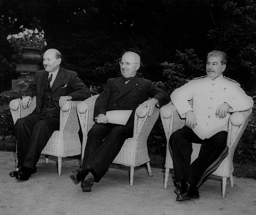 Photograph showing Clement Atlee, Harry Truman, and Joseph Stalin stead outdoors at the Potsdam Conference