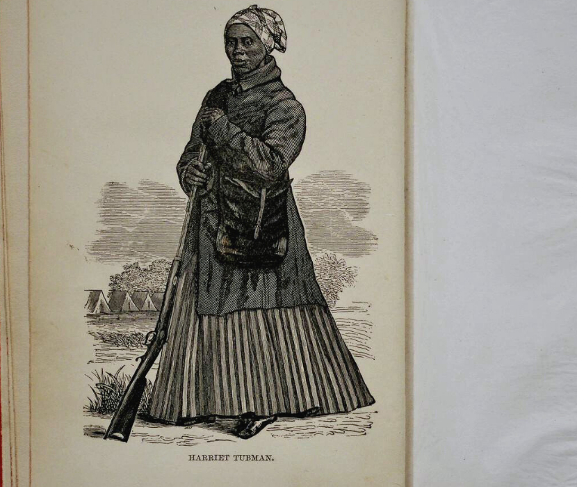 Engraving depicting Harriet Tubman holding a rifle with tents in the background