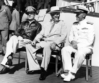 On board USS Baltimore (CA-68), at Pearl Harbor, Hawaii, 26 July 1944. Admiral William D. Leahy, the President's Chief of Staff, is standing in the left background. Official U.S. Navy Photograph, now in the collections of the National Archives