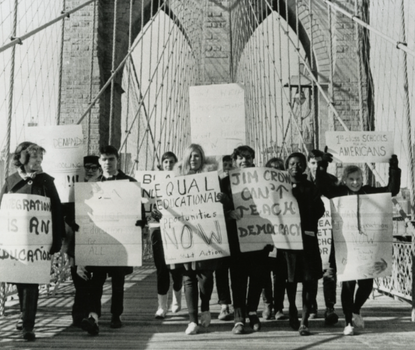 Black and white photograph of students protesting on Brooklyn Bridge