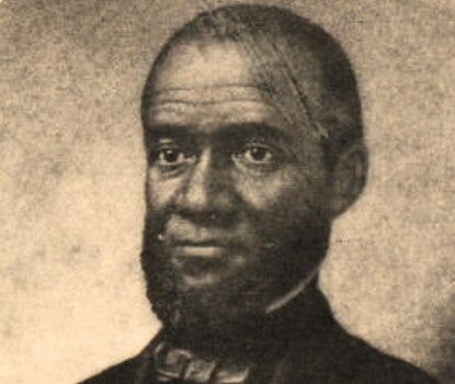An engraving of a bust of a bearded Black man wearing a black suit, white shirt, and dark bow tie, in three-quarter view looking toward the left