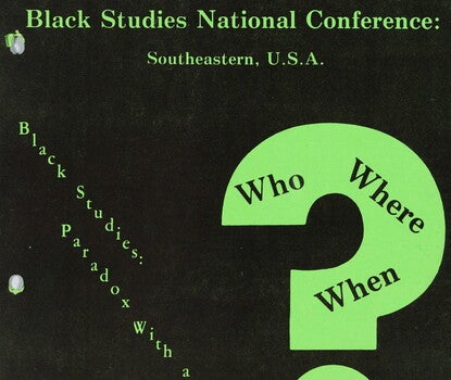 The cover of a conference program of green text on a black background reading [diagonally] "Black Studies: Paradox With a Promise" at left, and a large green question mark with "Who," "Where," "When," and "How" written in the mark. "Black Studies National Conference: Southeastern, U.S.A." at the top and "University of North Carolina at Charlotte, Charlotte, N.C., March 18-21, 1975" at the bottom