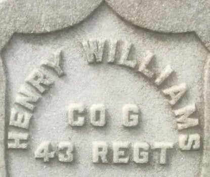 A military cemetery headstone with the name of a member of the United States Colored Troops.