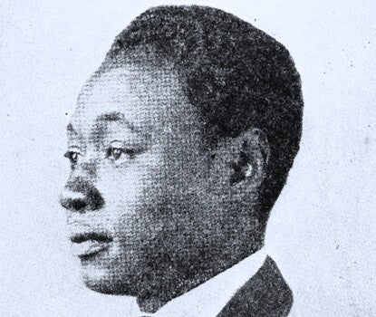 An engraving of Claude McKay, a Black man, in profile wearing a dark jacket, light-colored tie, and white shirt