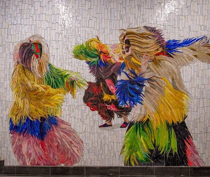 A tiled mosaic of three masked human figures dancing in long-fringed, multicolored body suits
