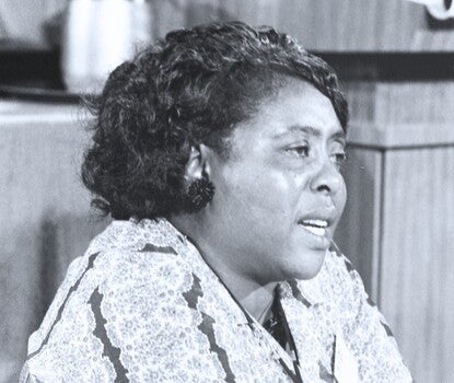 Fannie Lou Hamer, a Black woman, speaking while wearing a floral-patterned dress.