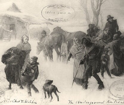 Black-and-white print of Black men, women, and children bundled in coats and shawls, unpacking a horse-drawn wagon in a snowy field, with leafless trees in the center midground and right background. A hut or cabin is in the left background, its roof and eaves covered with snow.