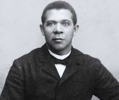 Black and white portrait of Booker T. Washington, three-quarter length, seated, facing front