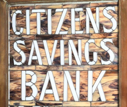A stained glass sign that reads “CITIZENS / SAVINGS / BANK”