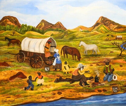 Two African American pioneer families in foreground with two children playing on left, two women and a small child near a covered wagon at center and two men drinking coffee around a campfire by a stream. 