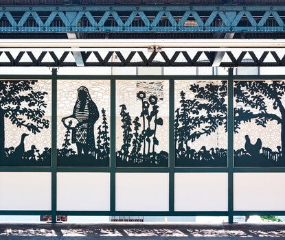 A five-piece mural made out of steel grates of a person working in a field.