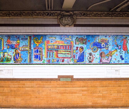 A blue tile mosaic mural with depictions of various historical figures