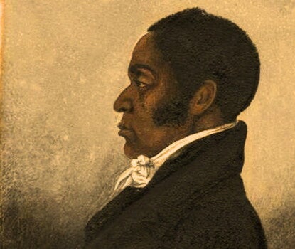 Portrait of a Black man with sideburns wearing a black suit with a white shirt, pictured in profile. 