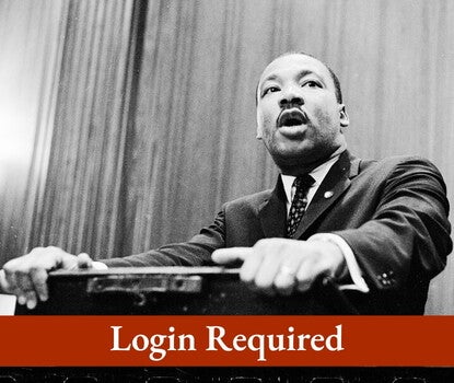 A black-and-white photograph of Martin Luther King Jr. speaking at a lectern. Login Required message is an overlay.