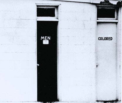 Three bathroom doors, labeled "Ladies," "Men," and "Colored."